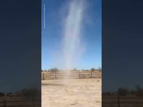 Dust devil tears up sand around mesmerized onlooker | USA TODAY #Shorts